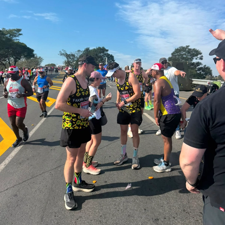 Comrades Marathon runners passing the Gerber Paper support station