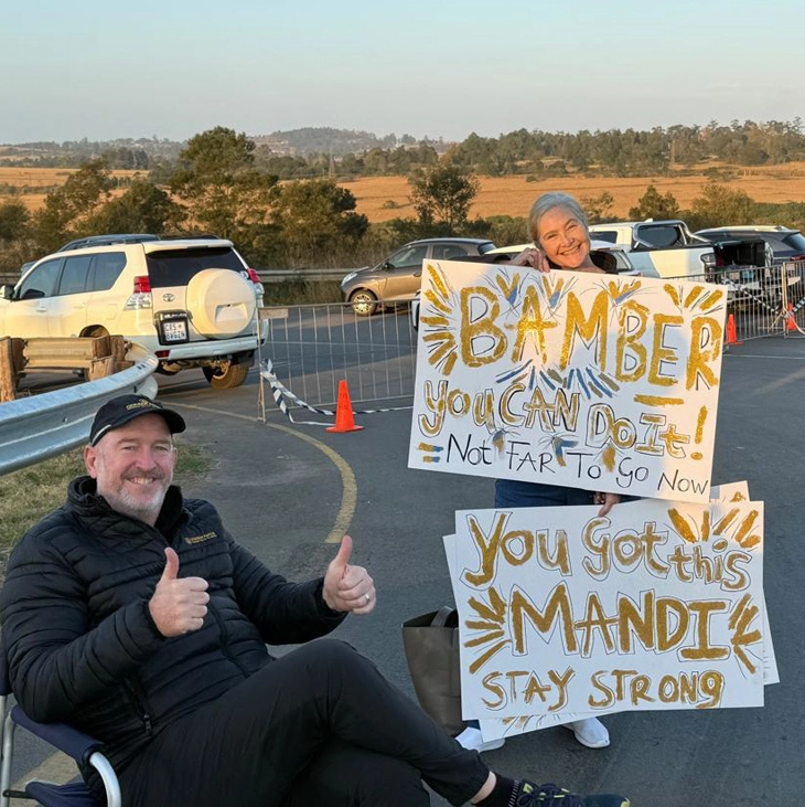 Gerber Paper supporter displaying motivational signs for Comrades Marathon participants