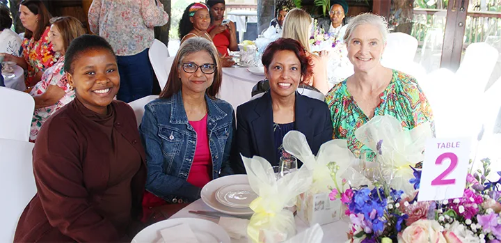 Guests gathered around a table at Gerber Paper’s annual Ladies’ Tea at Mangwanani Spa