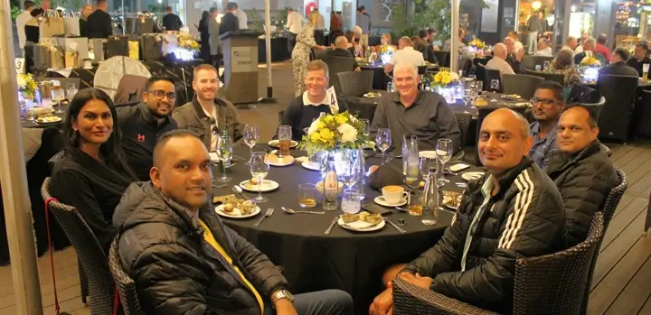 Customers and industry partners enjoying the post-golf dinner and networking event.