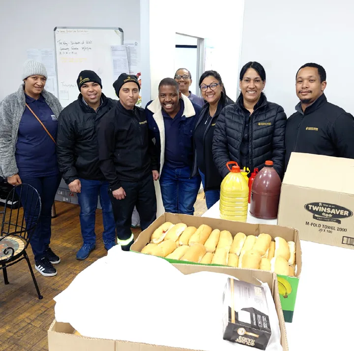 Gerber Paper Cape Town team preparing hot dogs at Centre of Hope for Mandela Da